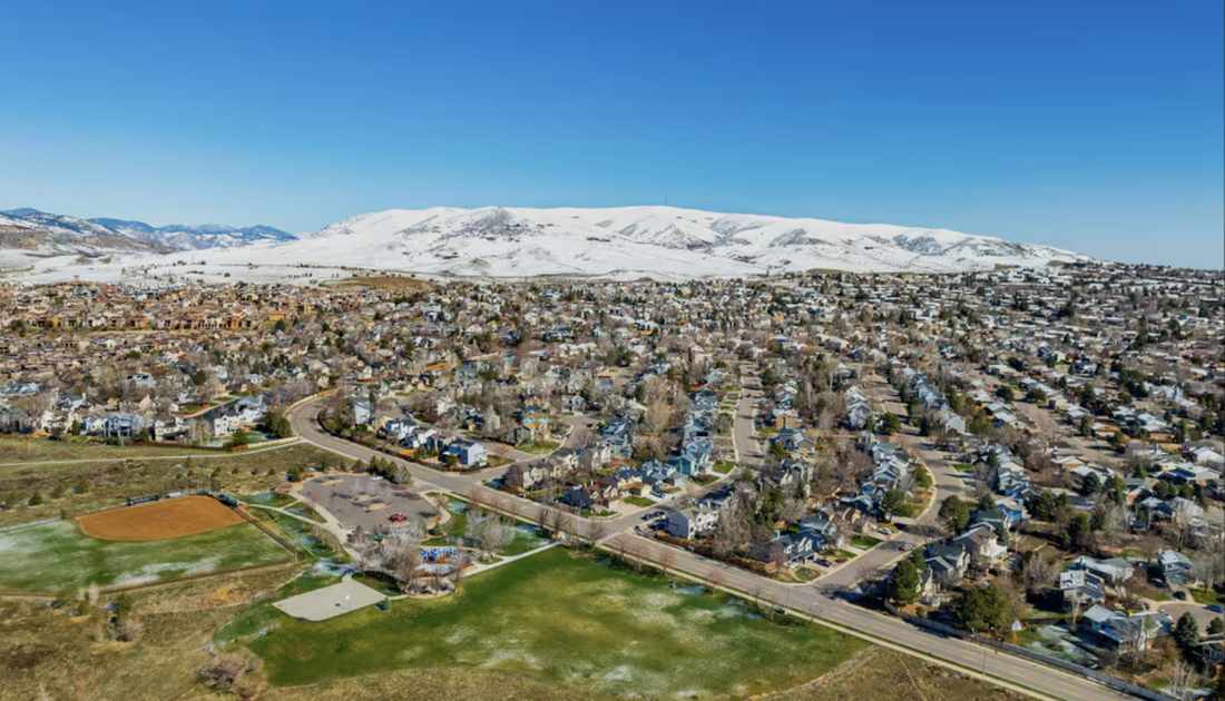Lakewood neighborhood aerial with snowy mountains