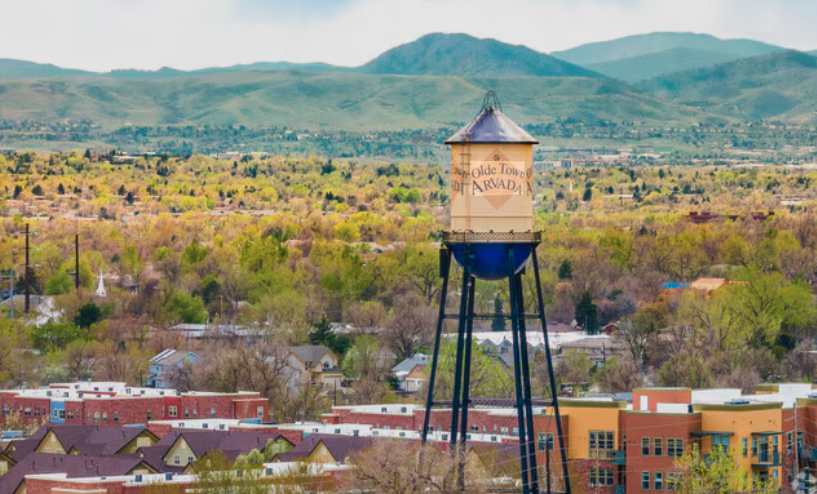 Olde Town Arvada water tower with mountain backdrop