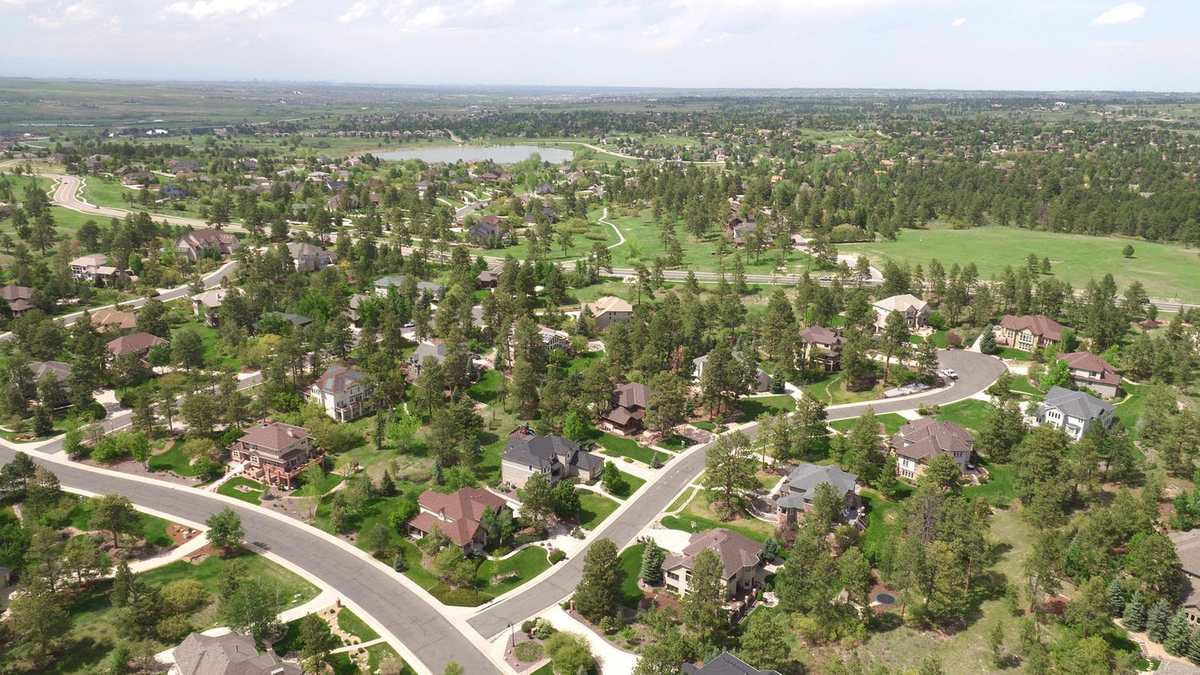 Parker neighborhood aerial with pines and lake