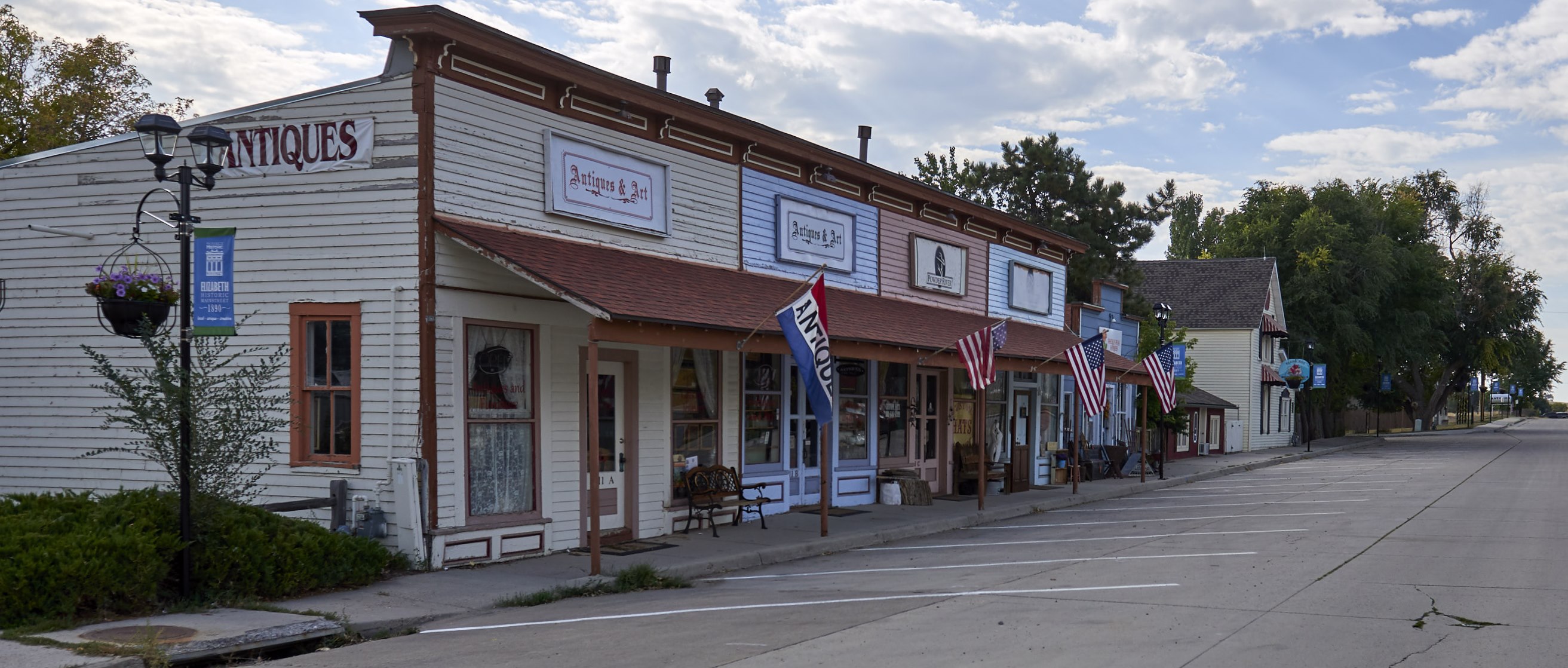Downtown Elizabeth Colorado storefronts with American flags